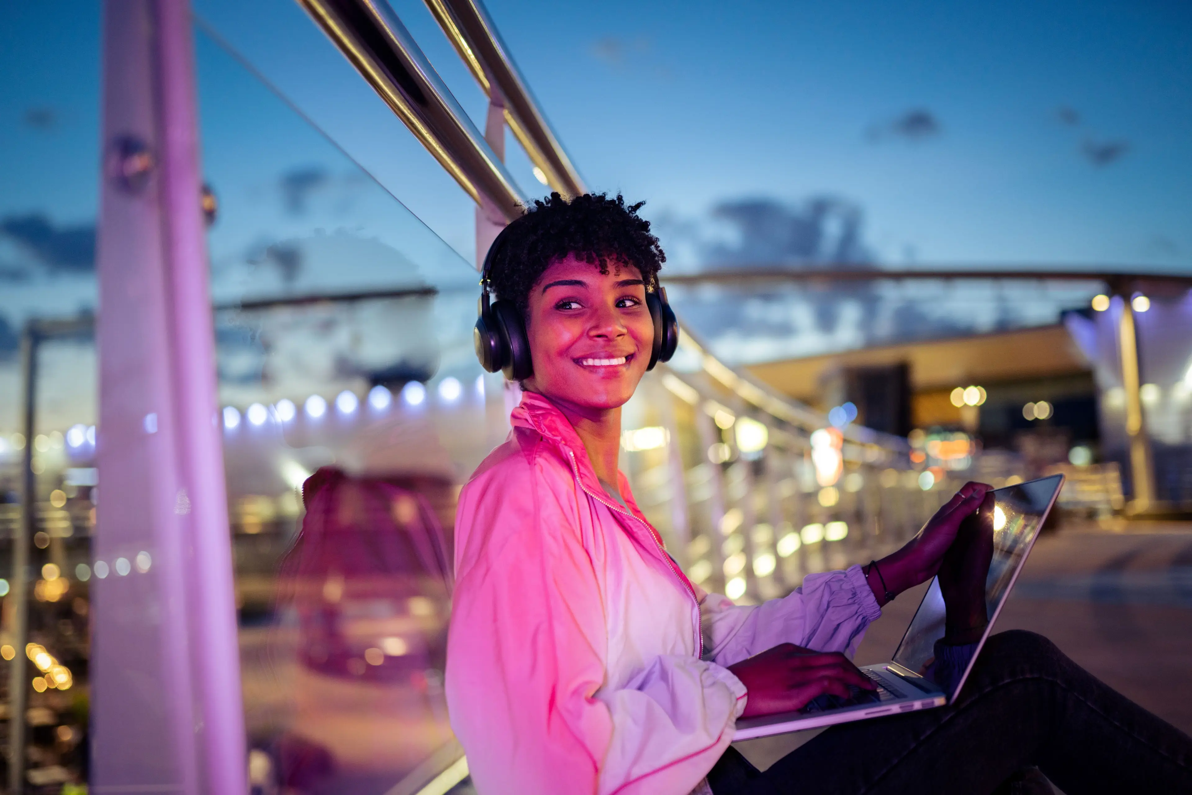 enercity Konzern Portrait Eine junge Frau mit Laptop vor Beleuchtung im Hintergrund