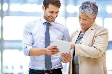 Mann und Frau schauen auf ein Tablet