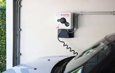 Nahaufnahme eines Elektroautos das in einer Garage geladen wird