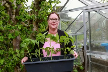 Antje Aiple mit Pflanzen in ihrem Garten